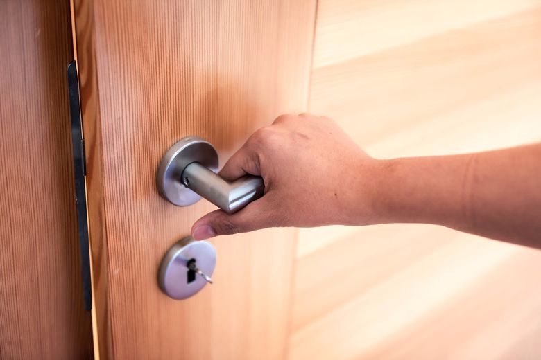 Woman Hand Is Holding Door Knob While Opening A Door In Bedroom, Lock Security System And Access Safety Of Doorway., Interior Design Of Doorknob Entering To Accessibility Private Room